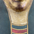  <em>Cartonnage Mummy Mask</em>, ca. 330 B.C.E.-50 C.E. Gesso, gilding, pigment, gauze or linen, 14 3/16 × 10 13/16 × 8 11/16 in. (36 × 27.5 × 22 cm). Brooklyn Museum, Bequest of Harold and Mildred Jacobs, 2022.1.1 (Photo: Brooklyn Museum, CUR.2022.1.1_view05.jpg)