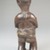 Mbala. <em>Standing Female Figure</em>, 19th or early 20th century. Wood, fiber, organic materials, 6 7/8 x 2 1/4 x 2in. (17.5 x 5.7 x 5.1cm). Brooklyn Museum, Museum Expedition 1922, Robert B. Woodward Memorial Fund, 22.1451. Creative Commons-BY (Photo: Brooklyn Museum, CUR.22.1451_back_PS5.jpg)