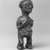 Mbala. <em>Standing Female Figure</em>, 19th or early 20th century. Wood, fiber, organic materials, 6 7/8 x 2 1/4 x 2in. (17.5 x 5.7 x 5.1cm). Brooklyn Museum, Museum Expedition 1922, Robert B. Woodward Memorial Fund, 22.1451. Creative Commons-BY (Photo: Brooklyn Museum, CUR.22.1451_print_threequarter_bw.jpg)