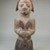Yorùbá. <em>Figure of a Devotee of Shango Holding an Oshe Shango</em>, late 19th or early 20th century. Wood, pigment, 15 x 4 15/16 x 5 3/4 in. (38.1 x 12.5 x 14.6 cm). Brooklyn Museum, Museum Expedition 1922, Robert B. Woodward Memorial Fund, 22.1518. Creative Commons-BY (Photo: Brooklyn Museum, CUR.22.1518_front_PS5.jpg)