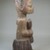 Yorùbá. <em>Figure of a Devotee of Shango Holding an Oshe Shango</em>, late 19th or early 20th century. Wood, pigment, 15 x 4 15/16 x 5 3/4 in. (38.1 x 12.5 x 14.6 cm). Brooklyn Museum, Museum Expedition 1922, Robert B. Woodward Memorial Fund, 22.1518. Creative Commons-BY (Photo: Brooklyn Museum, CUR.22.1518_side_PS5.jpg)