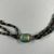  <em>Three Strand Necklace with Scarab</em>, ca. 1630-1539 B.C.E. Steatite, glaze, Scarab: 1/4 × 1/2 × 5/8 in. (0.7 × 1.2 × 1.6 cm). Brooklyn Museum, Gift of the Egypt Exploration Society, 26.162. Creative Commons-BY (Photo: Brooklyn Museum, CUR.26.162_view02.jpg)