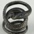  <em>Coiled Serpent</em>. Bronze, silver, 3/16 × Diam. 13/16 in. (0.5 × 2 cm). Brooklyn Museum, Charles Edwin Wilbour Fund, 37.1214E. Creative Commons-BY (Photo: Brooklyn Museum (in collaboration with Index of Christian Art, Princeton University), CUR.37.1214E_view1_ICA.jpg)