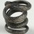  <em>Coiled Serpent</em>. Bronze, silver, 3/16 × Diam. 13/16 in. (0.5 × 2 cm). Brooklyn Museum, Charles Edwin Wilbour Fund, 37.1214E. Creative Commons-BY (Photo: Brooklyn Museum (in collaboration with Index of Christian Art, Princeton University), CUR.37.1214E_view3_ICA.jpg)