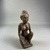  <em>Seated Female Figurine</em>, ca. 838–332 B.C.E. Wood, 4 7/16 × 1 7/8 × 1 3/4 in. (11.2 × 4.8 × 4.4 cm). Brooklyn Museum, Charles Edwin Wilbour Fund, 37.1527E. Creative Commons-BY (Photo: Brooklyn Museum, CUR.37.1527E_threequarter.JPG)