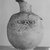  <em>Vase with Face of Bes on One Side</em>, 664-332 B.C.E. Clay, 4 13/16 x Diam. 2 3/8 in. (12.2 x 6 cm). Brooklyn Museum, Charles Edwin Wilbour Fund, 37.329E. Creative Commons-BY (Photo: Brooklyn Museum, CUR.37.329E_NegC_print_bw.jpg)