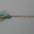  <em>Hair Pin of Insects, Flowers</em>. Color stones, feather mosaic, brass, 13/16 x 7 11/16 in. (2 x 19.5 cm). Brooklyn Museum, Frank L. Babbott Fund, 37.371.254. Creative Commons-BY (Photo: Brooklyn Museum, CUR.37.371.254_back.jpg)