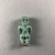  <em>Amulet of Pataikos</em>, 664-332 B.C.E. Faience, 1 1/2 × 11/16 × 1/2 in. (3.8 × 1.8 × 1.3 cm). Brooklyn Museum, Charles Edwin Wilbour Fund, 37.988E. Creative Commons-BY (Photo: , CUR.37.988E_view02.jpg)