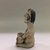 Tesuque. <em>Seated Figurine</em>, 20th century. Clay, slip, 6 7/8 × 2 3/4 × 3 1/4 in. (17.5 × 7 × 8.3 cm). Brooklyn Museum, Gift of Mary E. Johnson, 51.243.16. Creative Commons-BY (Photo: , CUR.51.243.16_view04.jpg)