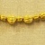 Greek. <em>Melon Shaped Bead Pierced Lengthwised with Beaded Rim</em>, late 4th century B.C.E. Gold, 3/16 x 3/8 in. (0.5 x 1 cm). Brooklyn Museum, Gift of Mr. and Mrs. Thomas S. Brush, 71.79.56. Creative Commons-BY (Photo: Brooklyn Museum, CUR.71.79.56-.76_detail06.jpg)