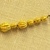 Greek. <em>Melon Shaped Bead Pierced Lengthwised with Plain Rim</em>, late 4th century B.C.E. Gold, 3/16 x 1/4 in. (0.5 x 0.6 cm). Brooklyn Museum, Gift of Mr. and Mrs. Thomas S. Brush, 71.79.73. Creative Commons-BY (Photo: Brooklyn Museum, CUR.71.79.56-.76_detail09.jpg)