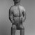 Possibly Wobe. <em>Seated Male Figure</em>, late 19th-early 20th century. Wood, metal studs, metal base, height (with base): 28 3/4 x 10 x 7 in. (73 x 25.4 x 17.8 cm). Brooklyn Museum, Gift of Fernandez Arman to the Jennie Simpson Educational Collection of African Art, 72.102.6. Creative Commons-BY (Photo: Brooklyn Museum, CUR.72.102.6_print_bw.jpg)