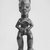 Lumbo. <em>Standing Figure with Legs Apart, Arms Akimbo and Hands Joined to Abdomen</em>, late 19th-early 20th century. Wood, 12 1/2 x 4 x 3 1/2 in. (31.7 x 10.2 x 9.0 cm). Brooklyn Museum, Gift of Mr. and Mrs. John A. Friede, 73.107.4. Creative Commons-BY (Photo: Brooklyn Museum, CUR.73.107.4_print_front_bw.jpg)