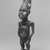 Kongo. <em>Standing Figure with Hands Resting on Hips</em>, 20th century. Wood, glass mirror, resin, feathers, 14 1/2 x 3 1/2 x 4 1/4 in. (36.8 x 9.0 x 11.5 cm). Brooklyn Museum, Gift of Robert A. Levinson, 75.76. Creative Commons-BY (Photo: Brooklyn Museum, CUR.75.76_print_threequarter_bw.jpg)