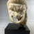 Roman. <em>Comic Mask, Held by a Right Hand</em>, perhaps 2nd century C.E. Marble, 7 1/2 × 5 1/4 × 3 9/16 in. (19 × 13.3 × 9 cm). Brooklyn Museum, Gift of Julius J. Ivanitsky in memory of his parents, Jacob and Ida Ivanitsky, 79.119.2. Creative Commons-BY (Photo: Brooklyn Museum, CUR.79.119.2_view01.jpg)