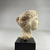 <em>Head of Aphrodite</em>, 332-30 B.C.E. Plaster, 2 13/16 × 1 15/16 × 2 3/16 in. (7.2 × 4.9 × 5.6 cm). Brooklyn Museum, Gift of the Estate of Fenwick W. Wall, 83.28. Creative Commons-BY (Photo: Brooklyn Museum, CUR.83.28_view06.jpg)
