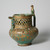  <em>Vase in the Shape of a Pitcher, Lajevardina ware</em>, mid-13th century. Ceramic; fritware, reticulated, molded, and painted in turquoise, red, white with gold-leaf overglaze over an opaque transparent glaze, 7 9/16 x 5 11/16 in. (19.2 x 14.5 cm). Brooklyn Museum, Gift of the Ernest Erickson Foundation, Inc., 86.227.67. Creative Commons-BY (Photo: Brooklyn Museum, CUR.86.227.67.jpg)