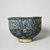 Hasan Al-Qashani. <em>Octagonal Bowl with Inscriptions</em>, late 12th century. Ceramic; fritware, with carved and molded decoration under a cobalt blue glaze, 4 5/16 x 6 3/8 in. (11 x 16.2 cm). Brooklyn Museum, Gift of the Ernest Erickson Foundation, Inc., 86.227.89. Creative Commons-BY (Photo: Brooklyn Museum, CUR.86.227.89_view2.jpg)