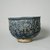 Hasan Al-Qashani. <em>Octagonal Bowl with Inscriptions</em>, late 12th century. Ceramic; fritware, with carved and molded decoration under a cobalt blue glaze, 4 5/16 x 6 3/8 in. (11 x 16.2 cm). Brooklyn Museum, Gift of the Ernest Erickson Foundation, Inc., 86.227.89. Creative Commons-BY (Photo: Brooklyn Museum, CUR.86.227.89_view3.jpg)