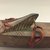 Santa Cruz Islander. <em>Club in Form of Boat</em>. Wood, coir, pigment, cloth, shell beads, 3 3/4 x 2 1/4 x 35 in. (9.5 x 5.7 x 88.9 cm). Brooklyn Museum, Gift of Marcia and John Friede and Mrs. Melville W. Hall, 87.218.81. Creative Commons-BY (Photo: , CUR.87.218.81_detail10.jpg)