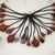 Kaapor. <em>Ornament</em>, 20th century. Seeds, gourds, plant fiber, 10 3/4 × 14 1/4 × 1 1/2 in. (27.3 × 36.2 × 3.8 cm). Brooklyn Museum, Anonymous gift, 88.89.9. Creative Commons-BY (Photo: Brooklyn Museum, CUR.88.89.9.jpg)