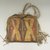 Comanche. <em>Woman's Fringed Raw Hide Bag with Strap for Carrying</em>, ca. 1900. Hide, pigment, 9 13/16 x 10 5/8 in. (25 x 27 cm). Brooklyn Museum, Brooklyn Museum Collection, X1120. Creative Commons-BY (Photo: Brooklyn Museum, CUR.X1120_view1.jpg)