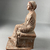  <em>Seated Figure of Woman with Fillet, Tanagra Style</em>. Terracotta, pigment, 6 1/2 × 3 9/16 × 4 1/8 in. (16.5 × 9 × 10.5 cm). Brooklyn Museum, Brooklyn Museum Collection, X249.75. Creative Commons-BY (Photo: Brooklyn Museum, CUR.X249.75_view03.jpeg)