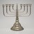 Jewish. <em>Hanukkah Menorah</em>, late 19th-early 20th century. Silver-plated metal, 10 1/2 x 11 1/2 x 5 3/8 in. (26.7 x 29.2 x 13.7cm). Assigned to the Brooklyn Museum by Jewish Cultural Reconstruction, Inc., L50.26.13. Creative Commons-BY (Photo: Brooklyn Museum, L50.26.13.jpg)