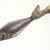 Charles Edenshaw (Haida, 1834-1924). <em>Clapper in Form of a Fish with Human Head for Finger Lever</em>, pre-1864. Cedar wood, pigment, 9 3/4 x 2 3/4 in. (24.8 x 7.0 cm). Collection of Christopher B. Martin, L61.3.1. Creative Commons-BY (Photo: Brooklyn Museum, L61.3.1_transp5628.jpg)