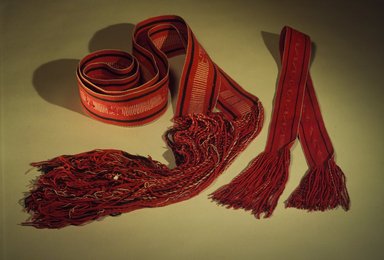 Navajo. <em>Woman's Belt (Sis Tichigi)</em>, late 19th-early 20th century. Wool and cotton commercial yarns, coral, ribbon, 130 x 3 3/8 in. (332.0 x 8.0 cm). Brooklyn Museum, Museum Expedition 1903, Museum Collection Fund, 03.325.3752. Creative Commons-BY (Photo: Brooklyn Museum, 03.325.3752.jpg)