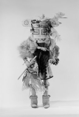 A:shiwi (Zuni Pueblo). <em>Kachina Doll (Helele)</em>, late 19th century. Wood, pigment, hair, fur, feathers, cotton cloth, hide, plant fiber, silk ribbon, 17 5/16 x 6 7/8 in. (44 x 17.5 cm). Brooklyn Museum, Museum Expedition 1903, Museum Collection Fund, 03.325.4652. Creative Commons-BY (Photo: Brooklyn Museum, 03.325.4652_acetate_bw.jpg)