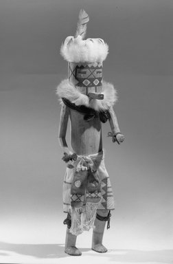 Mau-i (She-we-na (Zuni Pueblo)). <em>Kachina Doll (Etsa Teh)</em>, late 19th-early 20th century. Wood, feather, fur, paint, cotton, wool yarn, Height: 14 15/16 in. (38 cm). Brooklyn Museum, Museum Expedition 1904, Museum Collection Fund, 04.297.5365. Creative Commons-BY (Photo: Brooklyn Museum, 04.297.5365_acetate_bw.jpg)