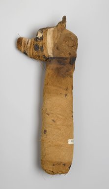  <em>Mummy of a Dog</em>, 305 B.C.E.-395 C.E. Animal remains, linen, pigment, 3 1/4 x 18 x 7 in. (8.3 x 45.7 x 17.8 cm). Brooklyn Museum, Charles Edwin Wilbour Fund, 05.308. Creative Commons-BY (Photo: Brooklyn Museum, 05.308_left_PS1.jpg)