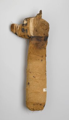  <em>Mummy of a Dog</em>, 305 B.C.E.–395 C.E. Animal remains, linen, pigment, 3 1/4 x 18 x 7 in. (8.3 x 45.7 x 17.8 cm). Brooklyn Museum, Charles Edwin Wilbour Fund, 05.308. Creative Commons-BY (Photo: Brooklyn Museum, 05.308_left_PS1.jpg)