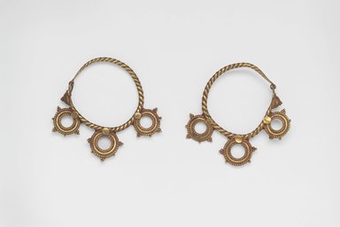  <em>Pair of Earrings with Three Wheel Ornaments</em>, 6th century C.E. Gold, 3/8 x 1 15/16 in. (0.9 x 5 cm). Brooklyn Museum, Ella C. Woodward Memorial Fund, 05.442a-b. Creative Commons-BY (Photo: Brooklyn Museum, 05.442a-b.jpg)