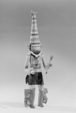 She-we-na (Zuni Pueblo). <em>Kachina Doll (Hetsululu)</em>, late 19th century. Wood, fabric, paint, yarn, cornhusk, paper, hide, shells, 18 × 5 × 5 in. (45.7 × 12.7 × 12.7 cm). Brooklyn Museum, Museum Expedition 1907, Museum Collection Fund, 07.467.8422. Creative Commons-BY (Photo: Brooklyn Museum, 07.467.8422_acetate_bw.jpg)