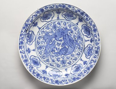  <em>Dish Depicting a Coiled Dragon</em>, late 17th century. Ceramic; stone paste, painted in cobalt blue under a transparent colorless glaze, Diam. 16 5/16 in. (41.4 cm). Brooklyn Museum, Museum Collection Fund, 11.33. Creative Commons-BY (Photo: Brooklyn Museum, 11.33_PS9.jpg)