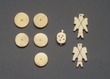 Osage. <em>Die in the Shape of a Falcon, from a Set of 7 Dice</em>, late 19th-early 20th century. Bone, pigment, 3/4 x 1 1/4 in. (1.9 x 3.2 cm). Brooklyn Museum, Museum Expedition 1911, Museum Collection Fund, 11.694.9000.6. Creative Commons-BY (Photo: , 11.694.9000.1-.7.jpg)