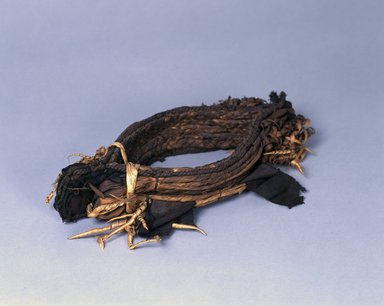 Ainu. <em>Crown</em>. Cloth, bear claws, 2 15/16 x 15 9/16 in. (7.5 x 39.5 cm). Brooklyn Museum, Gift of Herman Stutzer, 12.581. Creative Commons-BY (Photo: , 12.581_Ainu_project.jpg)