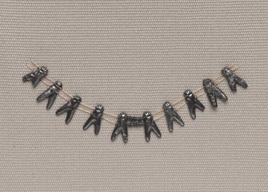  <em>Fly Necklace</em>, ca. 1539-1292 B.C.E. Silver, 1/2 x 4 1/4 in. (1.2 x 10.8 cm). Brooklyn Museum, Gift of the Egypt Exploration Fund, 14.641. Creative Commons-BY (Photo: Brooklyn Museum, 14.641_PS9.jpg)