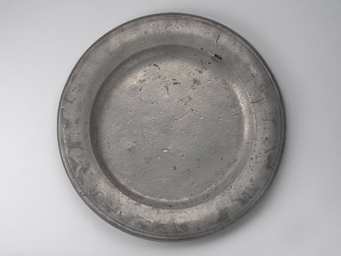 American. <em>Large Platter</em>, early 18th century. Pewter, 1/2 x 20 5/8 x 20 5/8 in. (1.3 x 52.4 x 52.4 cm). Brooklyn Museum, Gift of Luke Vincent Lockwood, 14.678. Creative Commons-BY (Photo: Brooklyn Museum, 14.678.jpg)