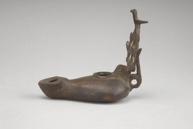 Coptic. <em>Lamp with Elaborate Handle</em>, 5th-6th century C.E. Bronze, 1 5/8 x 3 3/8 in. (4.2 x 8.6 cm). Brooklyn Museum, Gift of Evangeline Wilbour Blashfield, Theodora Wilbour, and Victor Wilbour honoring the wishes of their mother, Charlotte Beebe Wilbour, as a memorial to their father, Charles Edwin Wilbour, 16.133. Creative Commons-BY (Photo: Brooklyn Museum, 16.133_profile.jpg)