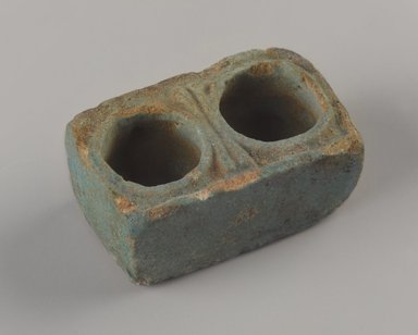  <em>Scribe's Inkwell</em>, 664 B.C.E.-395 C.E. Faience, 1 1/4 x 7/8 x 2 in. (3.2 x 2.2 x 5.1 cm). Brooklyn Museum, Gift of Evangeline Wilbour Blashfield, Theodora Wilbour, and Victor Wilbour honoring the wishes of their mother, Charlotte Beebe Wilbour, as a memorial to their father, Charles Edwin Wilbour, 16.139. Creative Commons-BY (Photo: Brooklyn Museum, 16.139_threequarter_PS9.jpg)