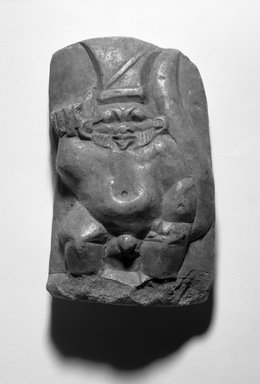  <em>Stela of Bes as a Warrior</em>, 200 B.C.E.-200 C.E. Limestone, pigment, 6 1/8 × 3 3/4 × 1/2 in. (15.6 × 9.5 × 1.3 cm). Brooklyn Museum, Gift of Evangeline Wilbour Blashfield, Theodora Wilbour, and Victor Wilbour honoring the wishes of their mother, Charlotte Beebe Wilbour, as a memorial to their father, Charles Edwin Wilbour, 16.142. Creative Commons-BY (Photo: Brooklyn Museum, 16.142_front_bw_IMLS.jpg)
