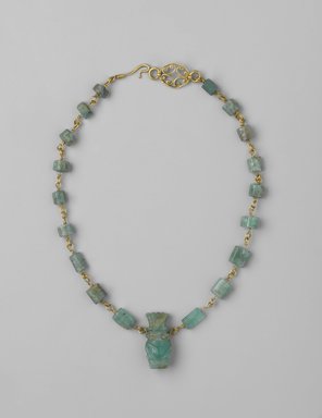  <em>Necklace</em>, 1st century C.E. Gold, beryl, silver, Necklace: 13 9/16 in. (34.4 cm) long; Bes figure: 1 x 7.16 in. (2.6 x 1.1 cm). Brooklyn Museum, Gift of Evangeline Wilbour Blashfield, Theodora Wilbour, and Victor Wilbour honoring the wishes of their mother, Charlotte Beebe Wilbour, as a memorial to their father, Charles Edwin Wilbour, 16.149. Creative Commons-BY (Photo: Brooklyn Museum, 16.149_PS2.jpg)