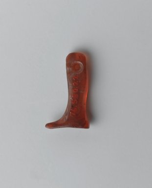  <em>Human Leg Amulet</em>, ca. 2500-2130 B.C.E. Carnelian, 7/16 x 3/16 x 13/16 in. (1.1 x 0.4 x 2 cm). Brooklyn Museum, Gift of Evangeline Wilbour Blashfield, Theodora Wilbour, and Victor Wilbour honoring the wishes of their mother, Charlotte Beebe Wilbour, as a memorial to their father Charles Edwin Wilbour, 16.580.22. Creative Commons-BY (Photo: Brooklyn Museum, 16.580.22_front_PS2.jpg)
