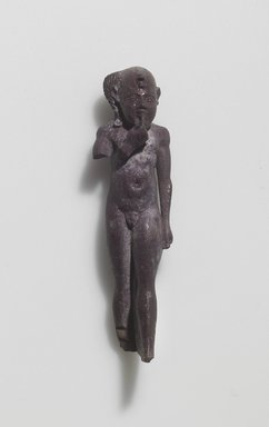  <em>Figure of the Child Horus Standing</em>, 664-525 B.C.E. Faience, 2 1/2 × 11/16 × 5/8 in. (6.3 × 1.7 × 1.6 cm). Brooklyn Museum, Gift of Evangeline Wilbour Blashfield, Theodora Wilbour, and Victor Wilbour honoring the wishes of their mother, Charlotte Beebe Wilbour, as a memorial to their father Charles Edwin Wilbour, 16.580.61. Creative Commons-BY (Photo: Brooklyn Museum, 16.580.61.jpg)