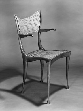 Dan Johnson Studio, a Division of Arch Industries. <em>"Gazelle" Armchair</em>, designed 1956. Walnut, cane, brass, 37 11/16 x 21 x 23in. (95.7 x 53.3 x 58.4cm). Brooklyn Museum, H. Randolph Lever Fund, 1989.113. Creative Commons-BY (Photo: Brooklyn Museum, 1989.113_bw.jpg)