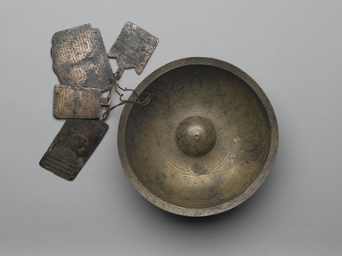 <em>Chihil Kilid (Forty Keys) Divination Bowl with Inscriptions, Zodiac Signs, and Four Plaquettes</em>, 1679. Copper alloy (brass), engraved with repoussé center and inlaid with black composites, 3in. (7.6cm). Brooklyn Museum, Gift of Mrs. Charles K. Wilkinson in memory of her husband, 1989.149.11. Creative Commons-BY (Photo: Brooklyn Museum, 1989.149.11_PS2.jpg)