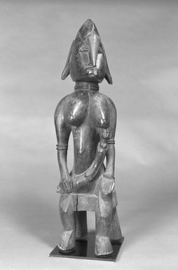 Senufo. <em>Figure of a Seated Mother and Child</em>, 20th century. Wood, 25 x 7 x 8 in. (63.5 x 17.8 x 20.3 cm). Brooklyn Museum, The Adolph and Esther D. Gottlieb Collection, 1989.51.50. Creative Commons-BY (Photo: Brooklyn Museum, 1989.51.50_bw.jpg)
